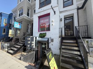 Doobie District storefront at 1526 U Street NW, with the green Doobie District sign, sidewalk sign and steps down to the basement entrance